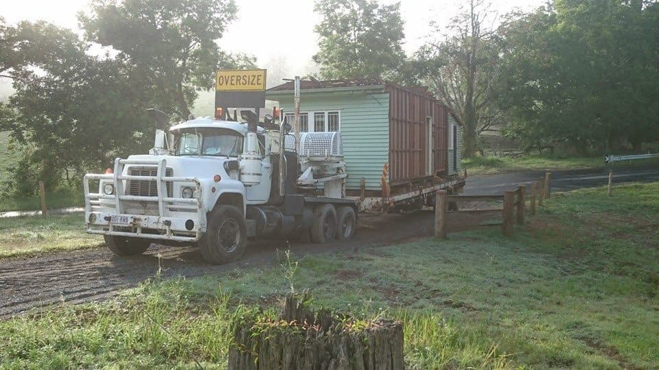 A house been carried for relocation on a truck by Meier House Removals