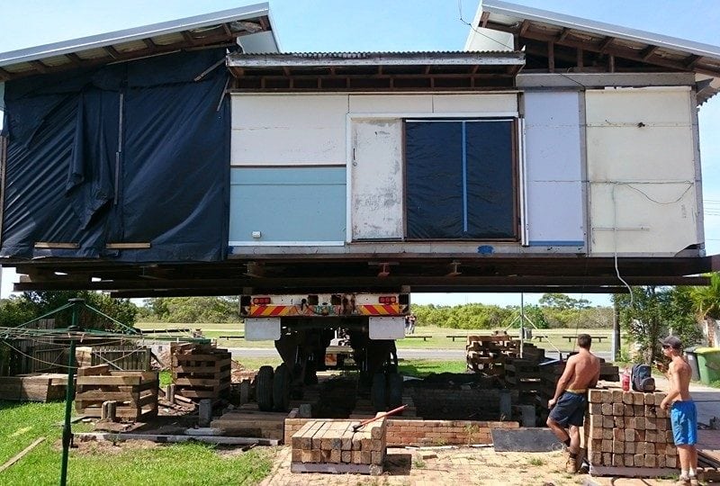 A house re-positioned in vertical direction by a hydraulic truck