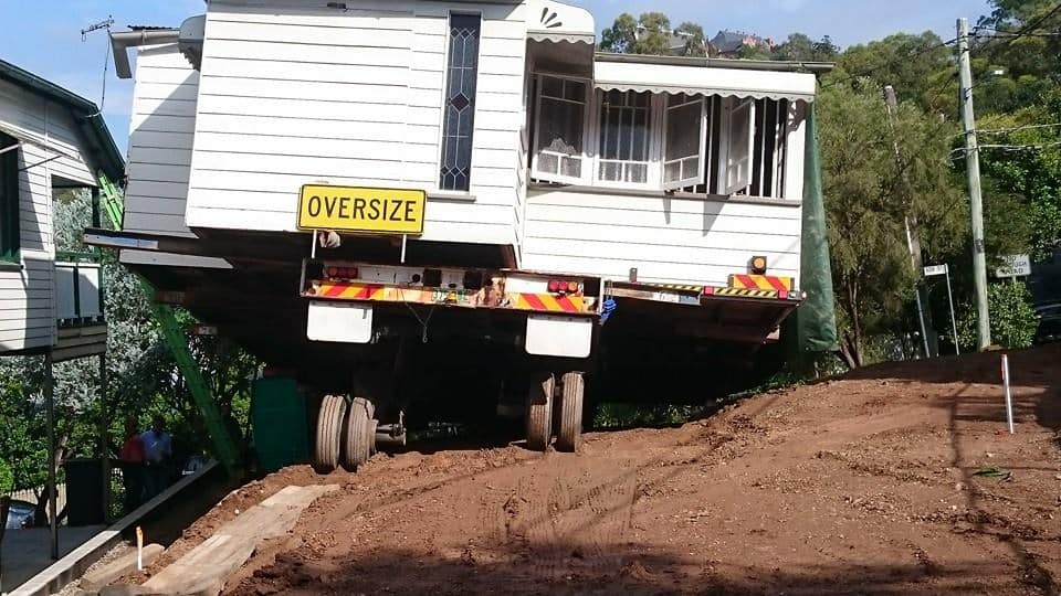 A house raised and kept on a trailer for relocation